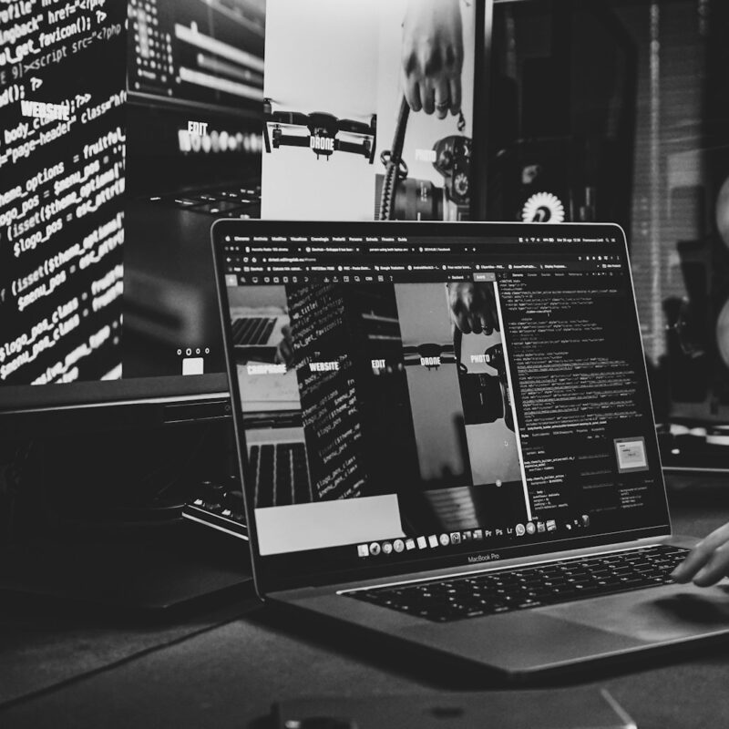 black and silver laptop computer on black table